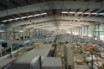 Packages in a distribution center whooshed along by a conveyor
